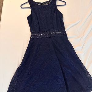 Wore this once to a wedding. Very fine and pretty details. Dark navy blue.